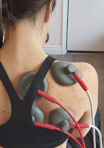 electric suction cups on a female patients shoulder