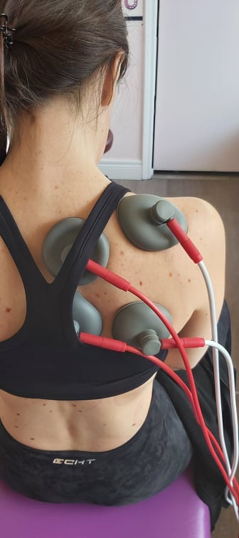 electric suction cups on a  female patients shoulder