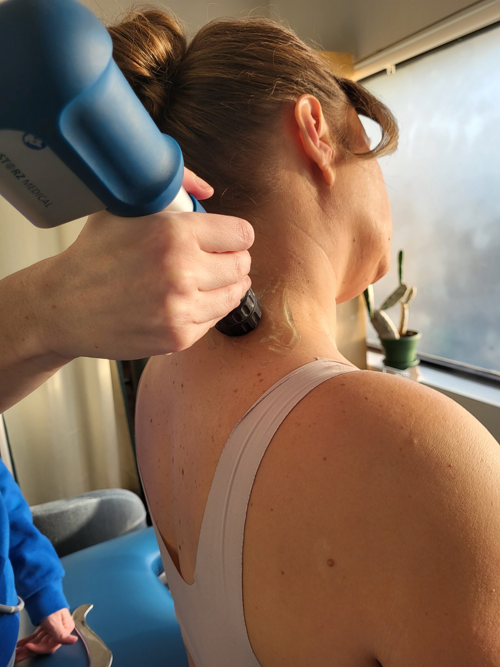 patient's cervical spine being treated with shockwave therapy for headaches