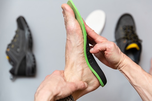 Orthotic Insole Fitting For Arch Support Hand Fitting Orthotic Insole To Foot For Arch Support