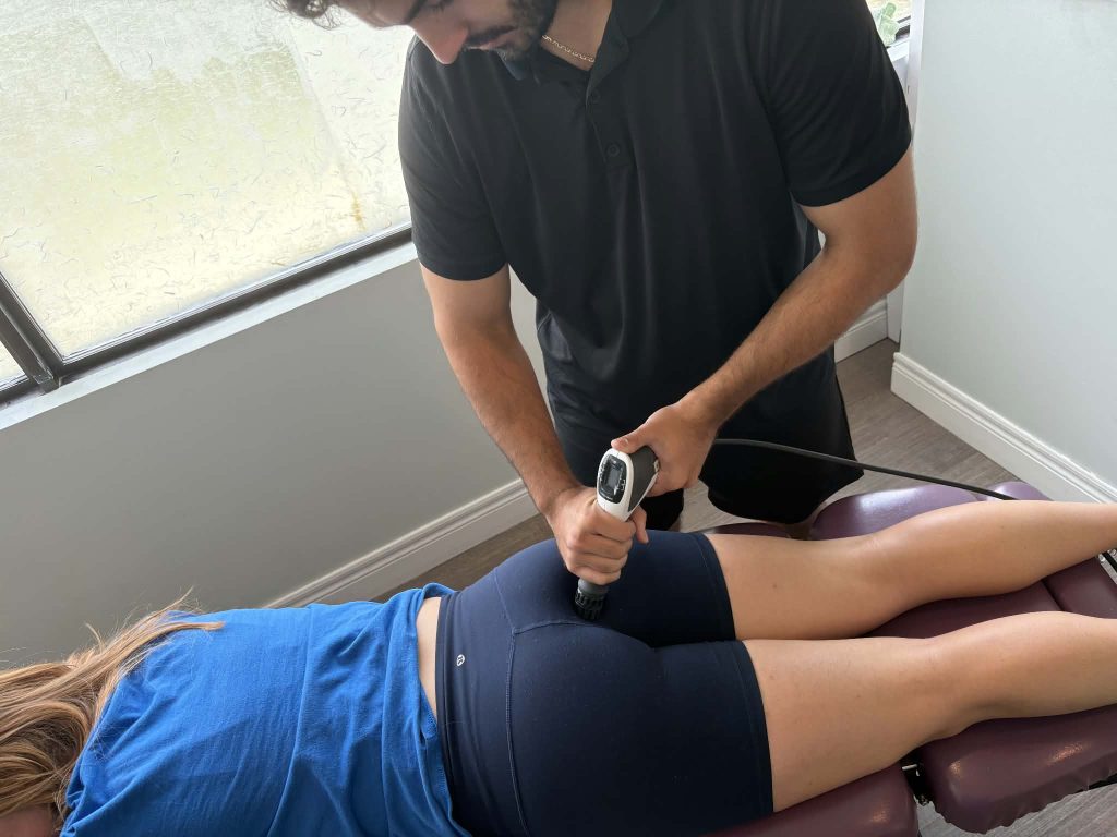 Dr. Alex treating a patients bruised tailbone