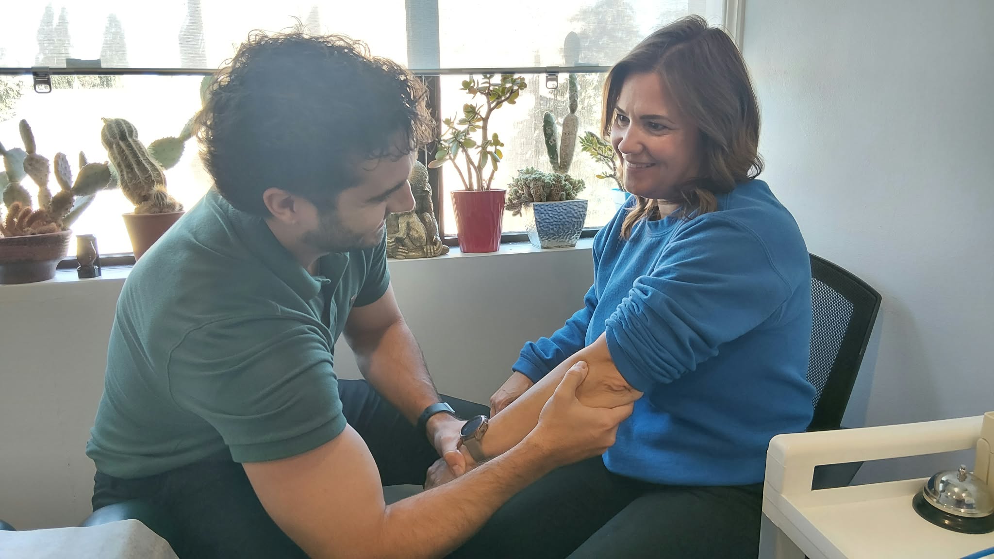 Dr Alex assessing a veterans affairs patients elbow