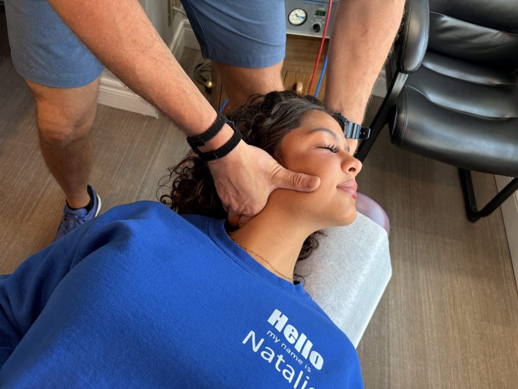 Dr. Steve adjusting a patients neck with his TFCC brace on, this is one of the little motions that can hurt TFCC injuries!