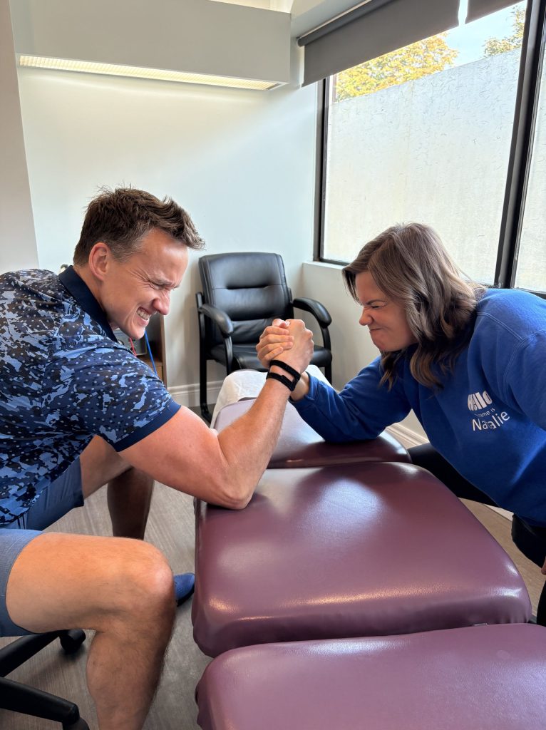 Dr. Steve and Natalie having an arm wrestling competition, Things should not do with a TFCC injury.